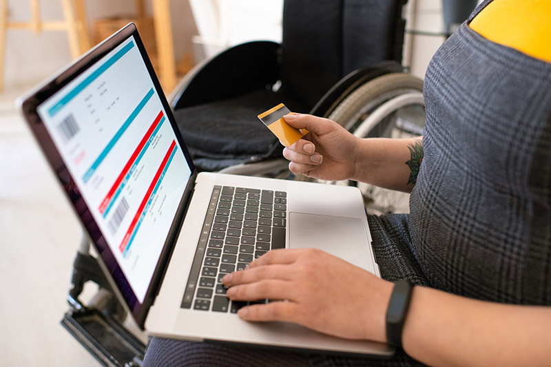 disabled woman purchasing online with a credit card